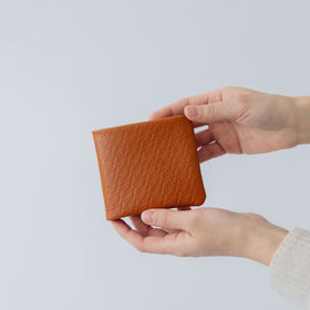 COSMIC WONDER monogram embossed light leather bifold wallet
