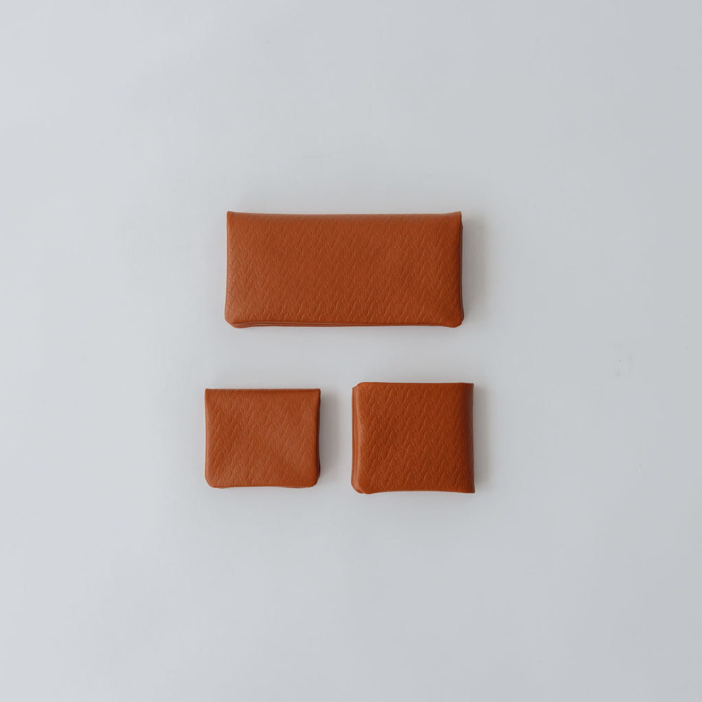 COSMIC WONDER monogram embossed light leather bifold wallet