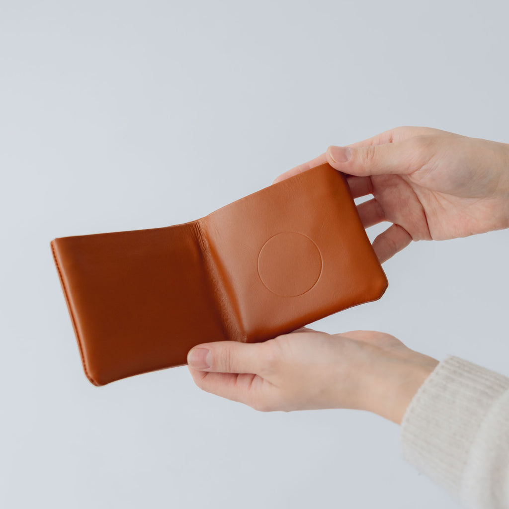 COSMIC WONDER monogram embossed light leather bifold wallet