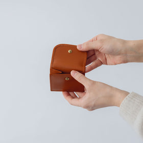 COSMIC WONDER monogram embossed light leather bifold wallet