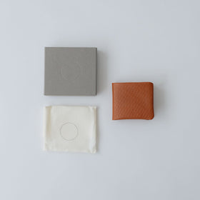 COSMIC WONDER monogram embossed light leather bifold wallet